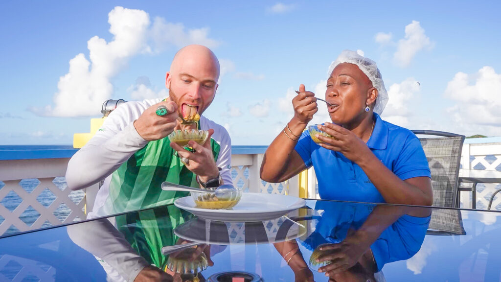 David Hoffmann and a local cook named Naz enjoy curry octopus by the ocean in Dominica | Davidsbeenhere