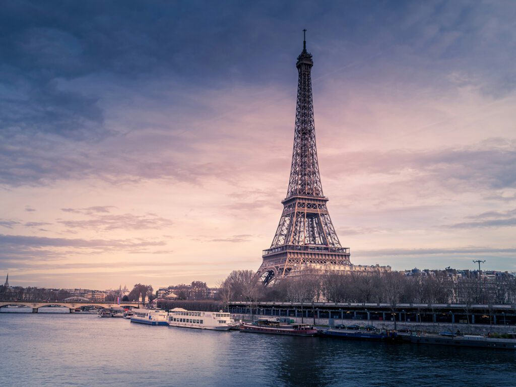 The Eiffel Tower, one of dozens of Paris Olympics venues, with the Seine  River in the foreground | Davidsbeenhere