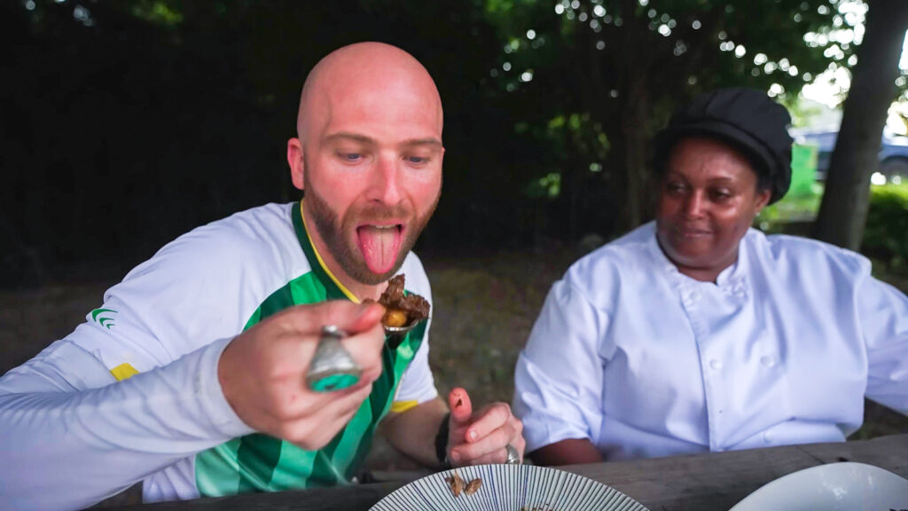 David Hoffmann eats a spoonful of wild food prepared by a chef in Dominica | Davidsbeenhere